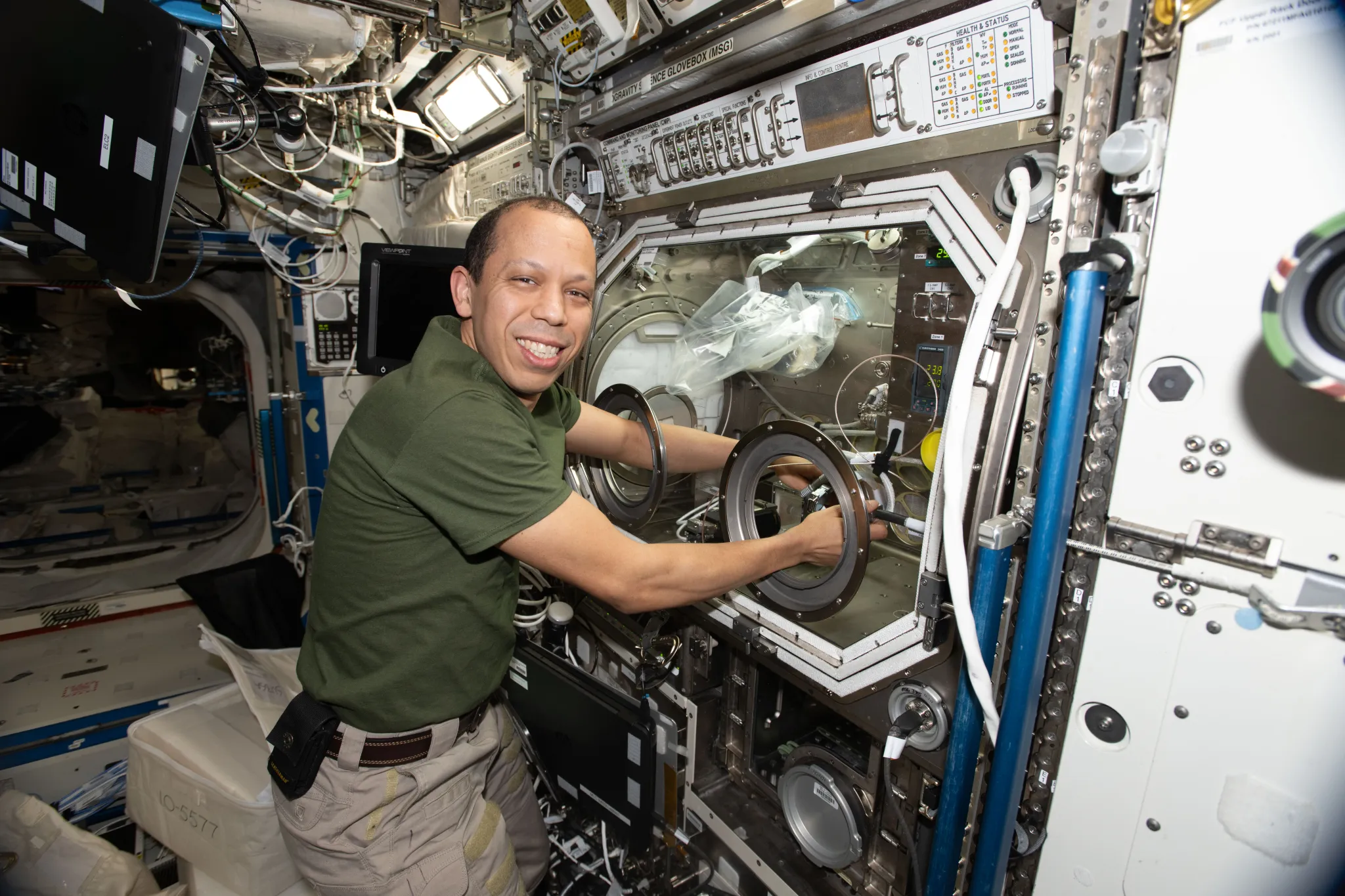 NASA astronaut Chris Williams works with Microgravity Science Glovebox