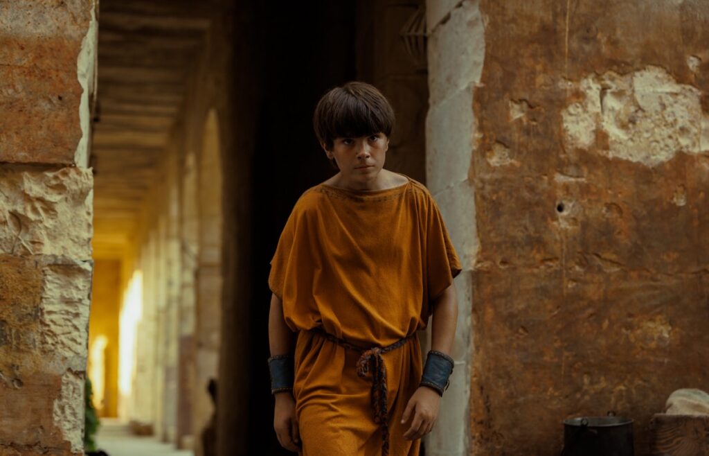 Avianius (Frankie Treadaway) strides home through the streets of Pompeii.