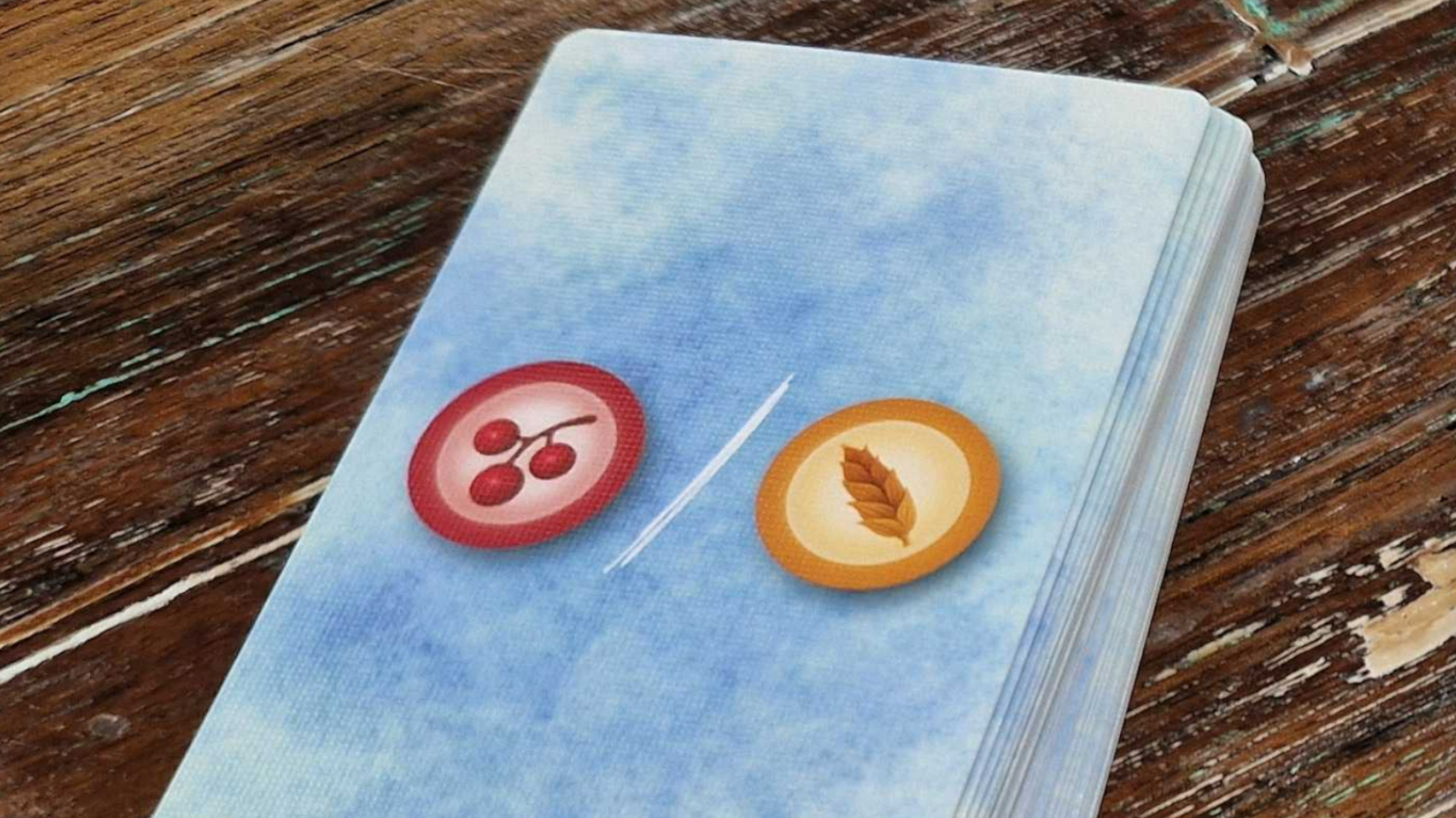 A face-down deck of Wingspan Pocket cards on a wooden surface